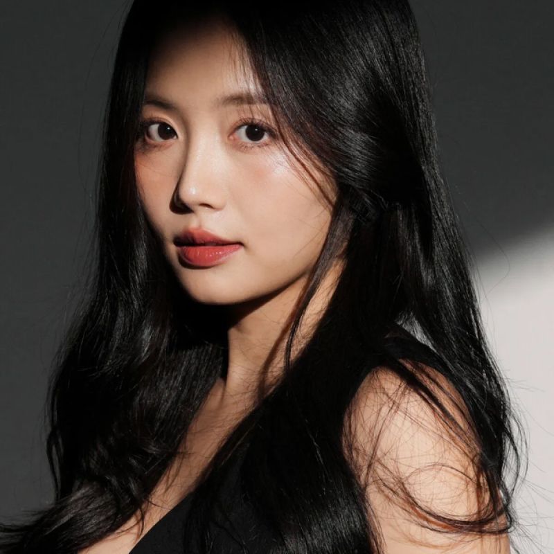 Portrait of a woman with long black hair.