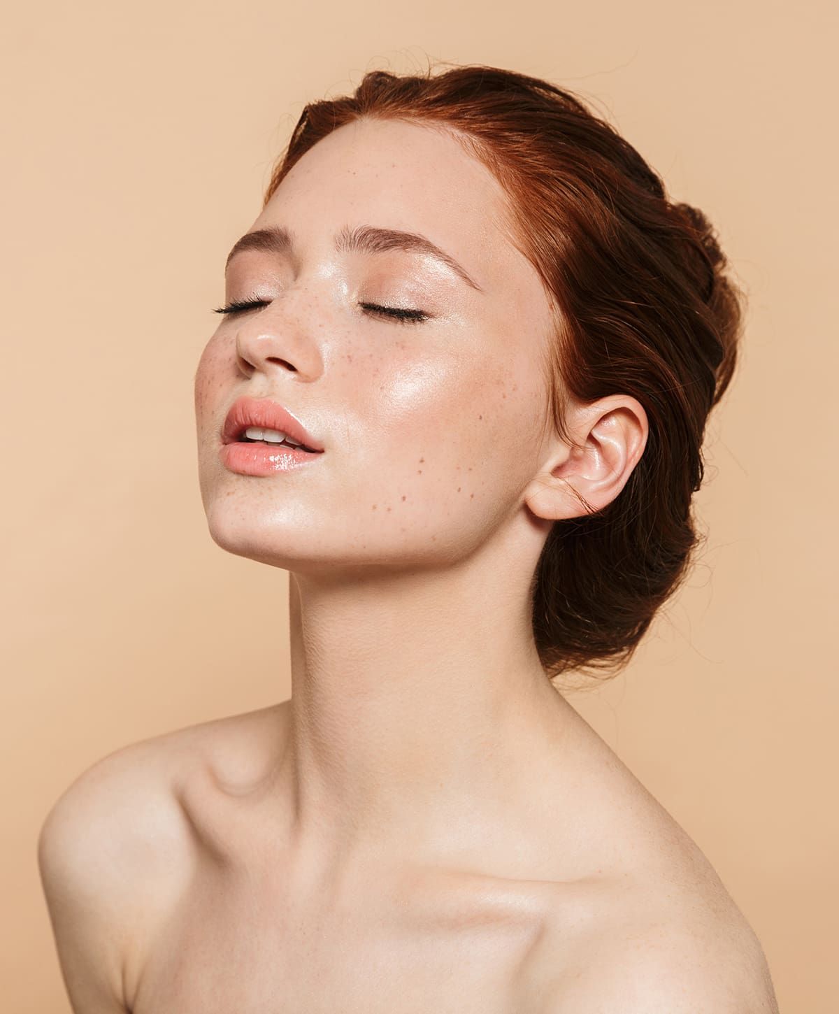 Close-up of woman with radiant skin and closed eyes.