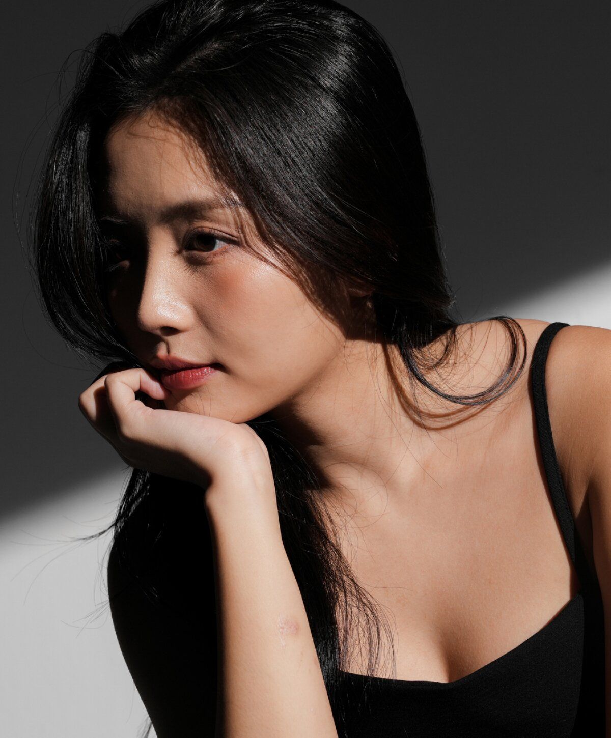 Profile of a woman in dramatic lighting.