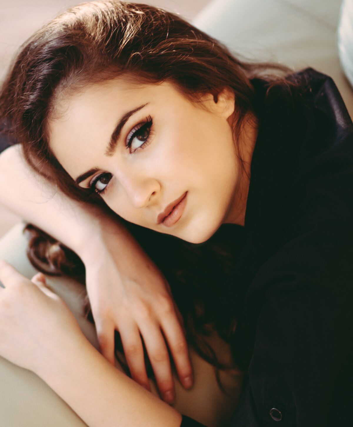 Close-up portrait of a woman with a thoughtful expression.