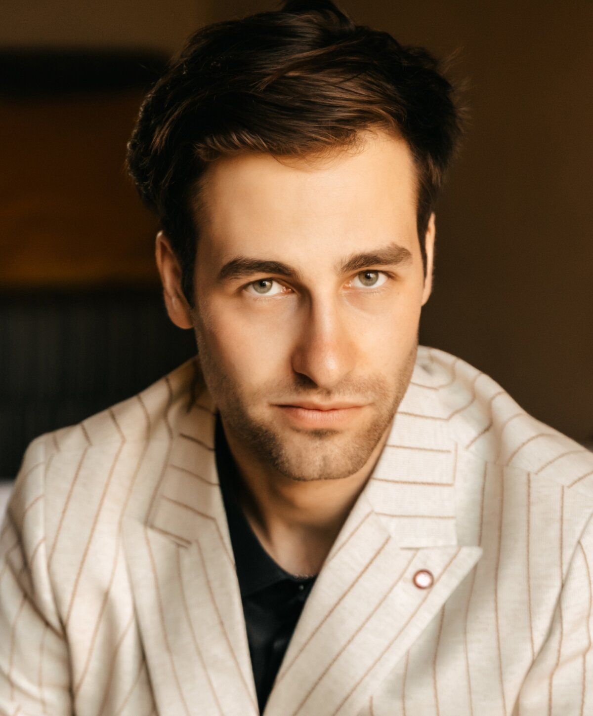 Man in striped suit with serious expression.