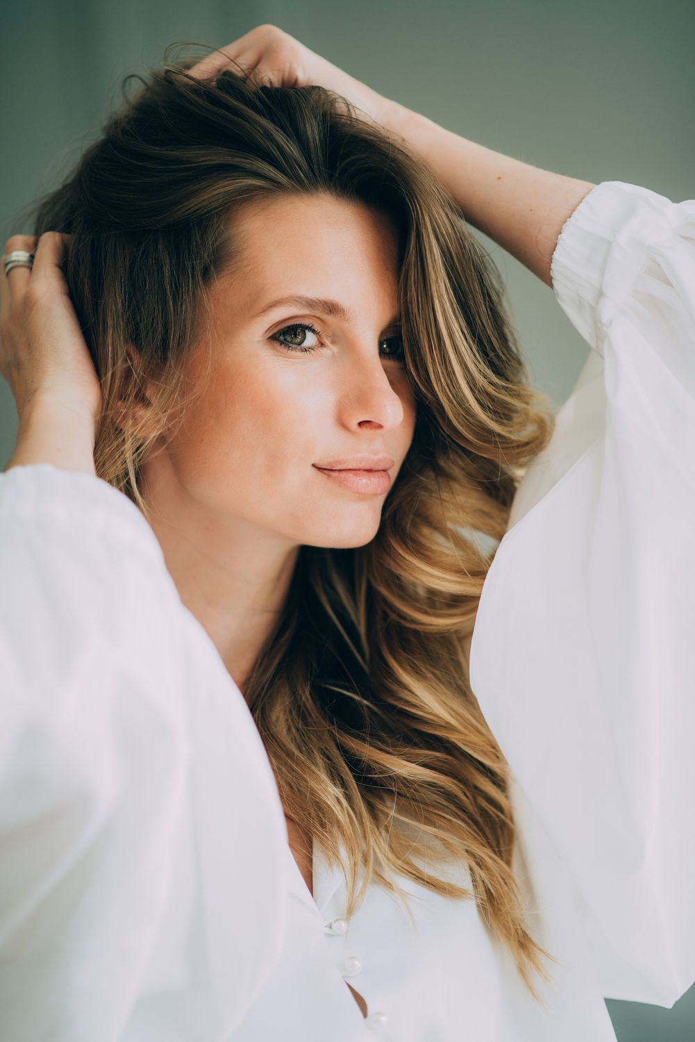 Woman with wavy hair and white blouse.