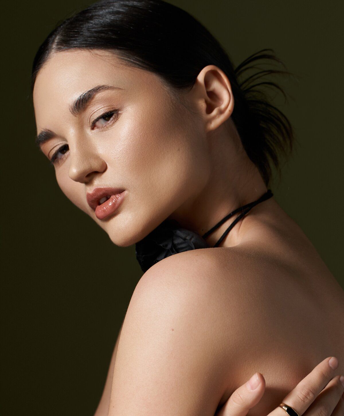 Woman with elegant makeup and soft expression.