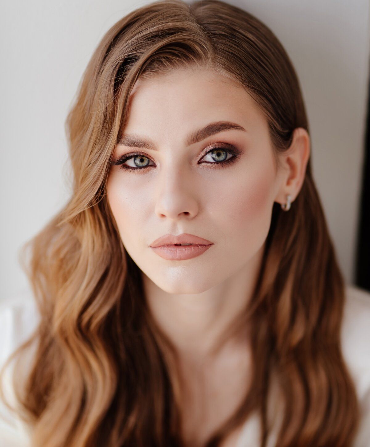 Portrait of a woman with wavy brown hair.