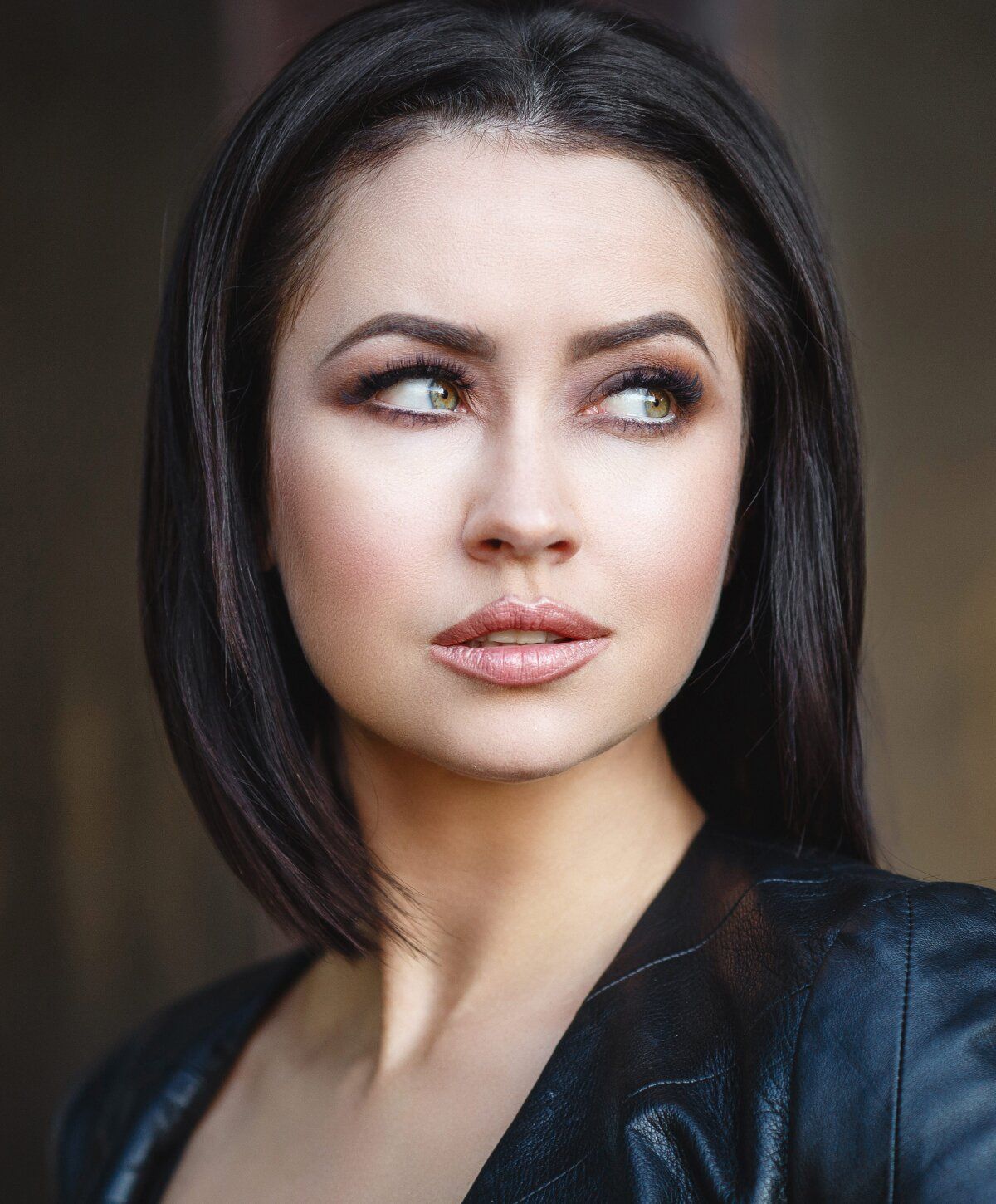 Woman with dark hair and striking makeup.