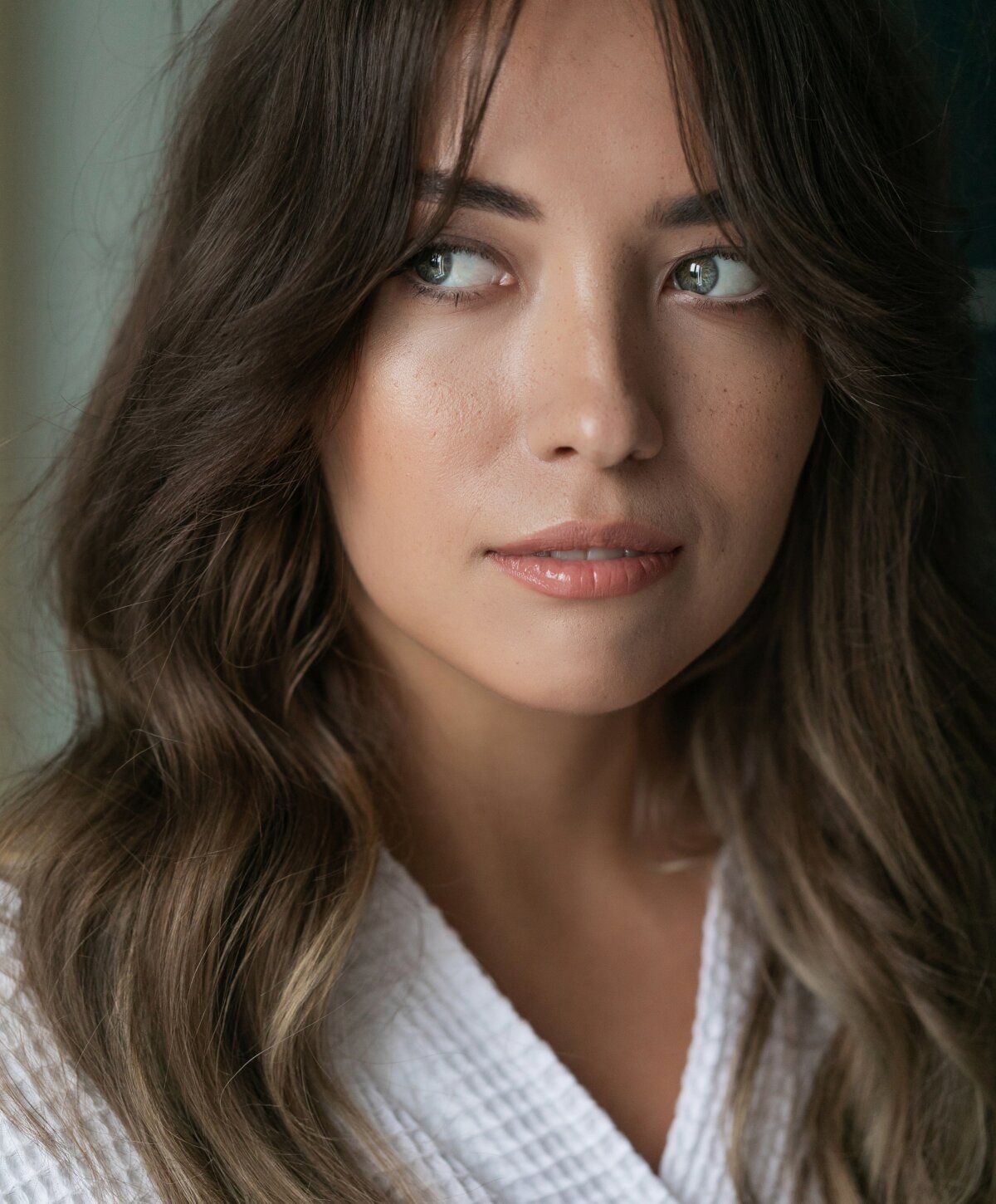 Woman with brown hair and natural makeup.