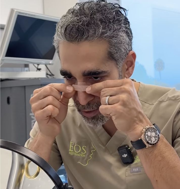 Man applying a skincare treatment in clinic.