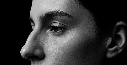 Close-up of a woman's profile in black and white.