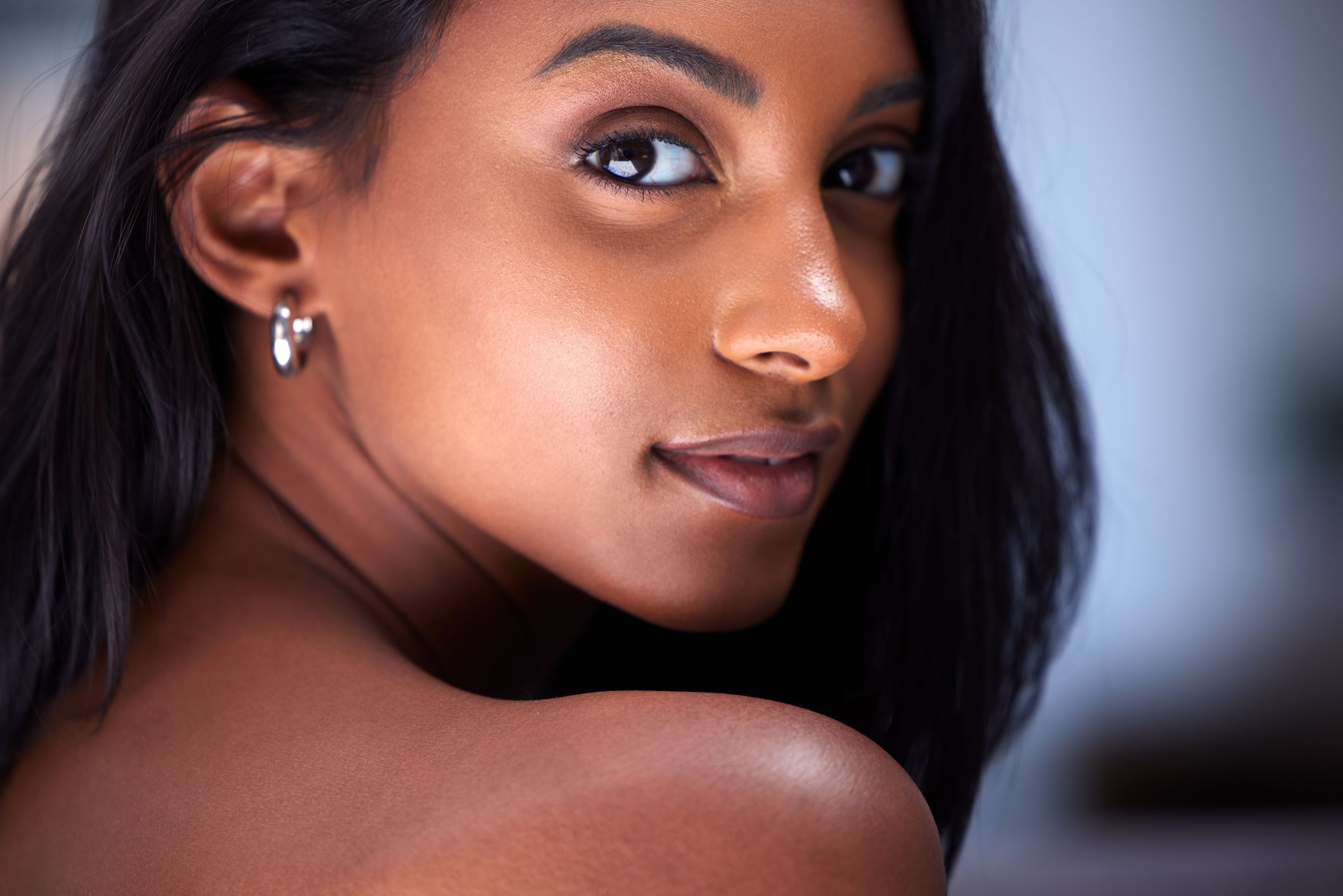 Portrait of a woman looking over her shoulder.