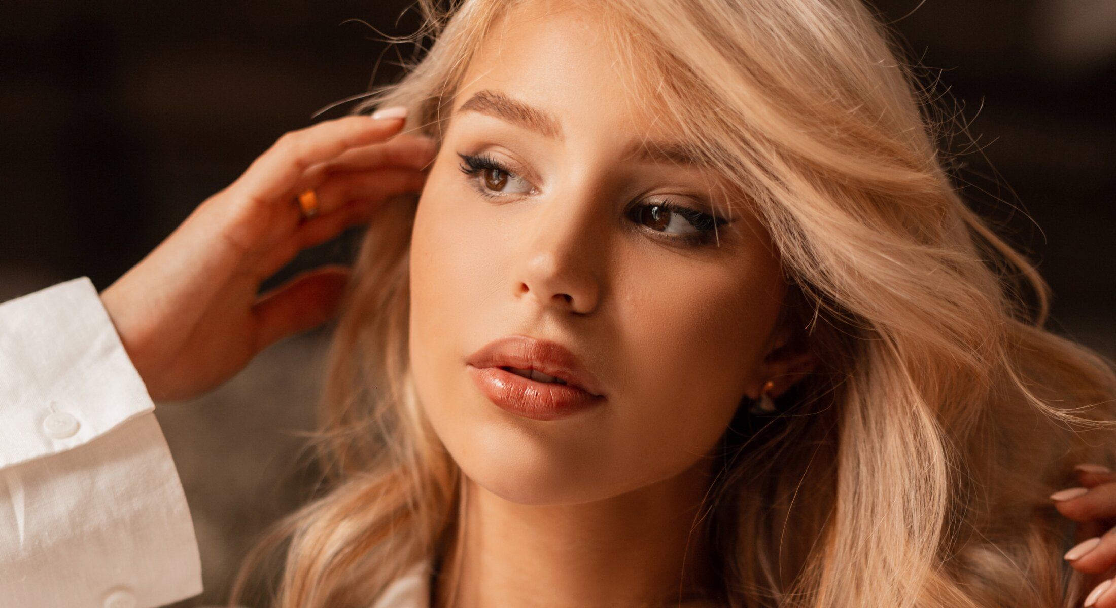 Close-up of Beverly Hills functional rhinoplasty model with blonde hair and makeup.