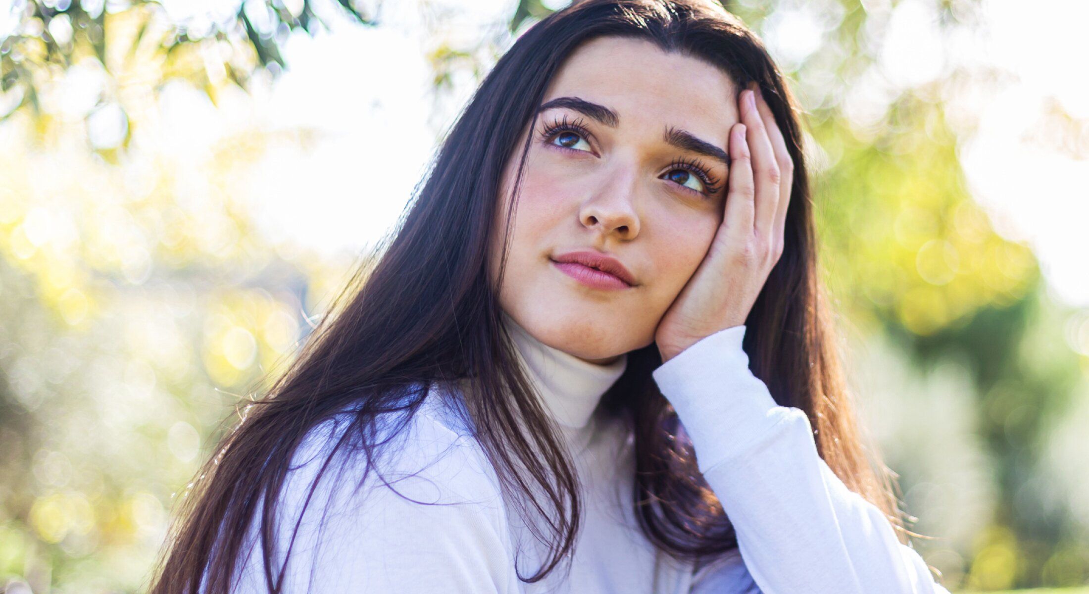 Thoughtful young woman in natural lighting.