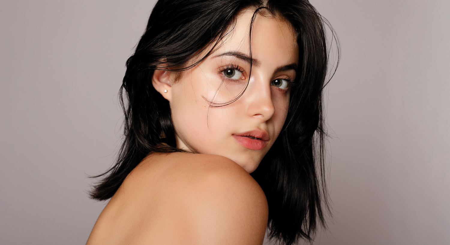 Close-up of woman with striking facial features.